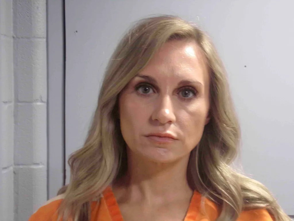 Misty Roberts seen in an orange uniform in mugshot
