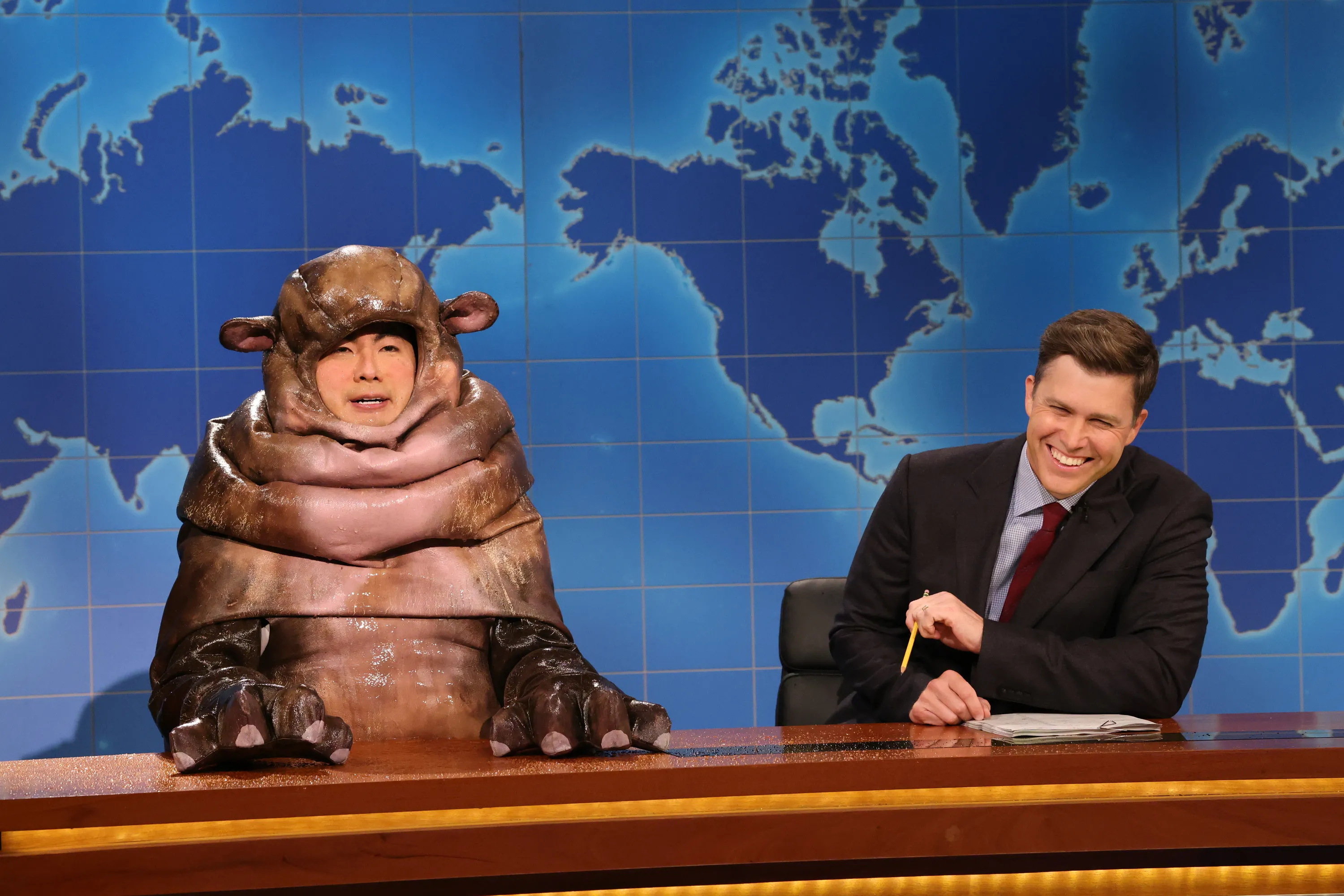 Bowen Yang as Moo Dang the hippo and Colin Jost during Weekend Update on Saturday Night Live.