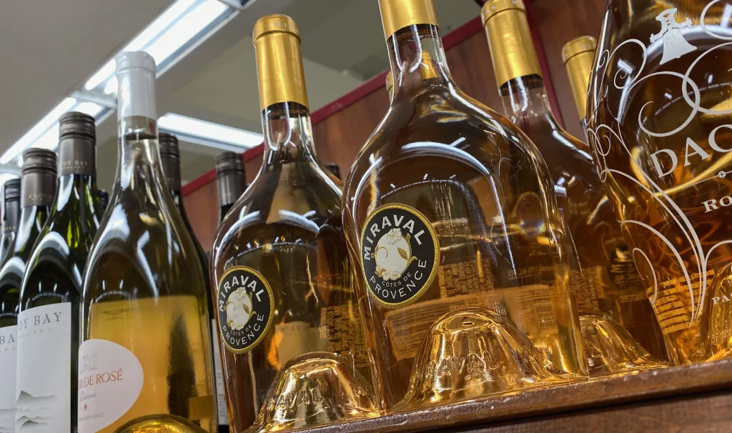 Bottles of Chateau Miraval Cotes de Provence rosé wine on a shelf in a store.
