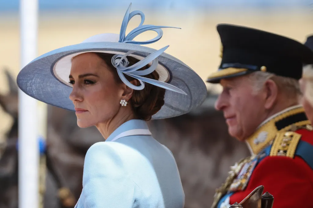 Catherine, Princess of Wales, in a light blue hat and suit, next to King Charles III in uniform at Trooping the Colour.