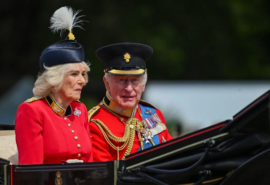 Britain's King Charles and Queen Camilla arrive for the Trooping the Colour parade in a horse-drawn carriage.