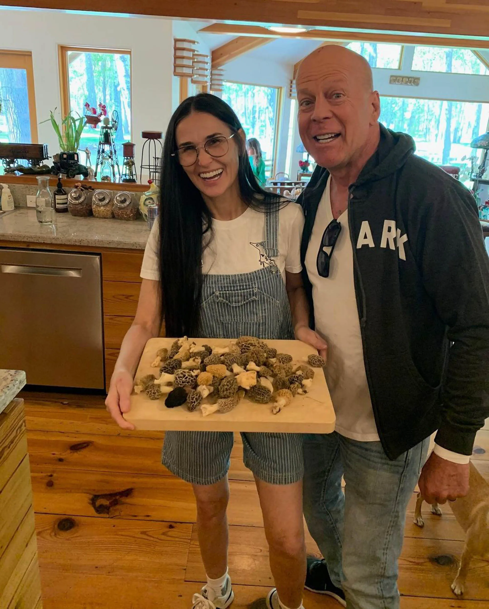 Bruce Willis and Demi Moore smiling with a tray of mushrooms.