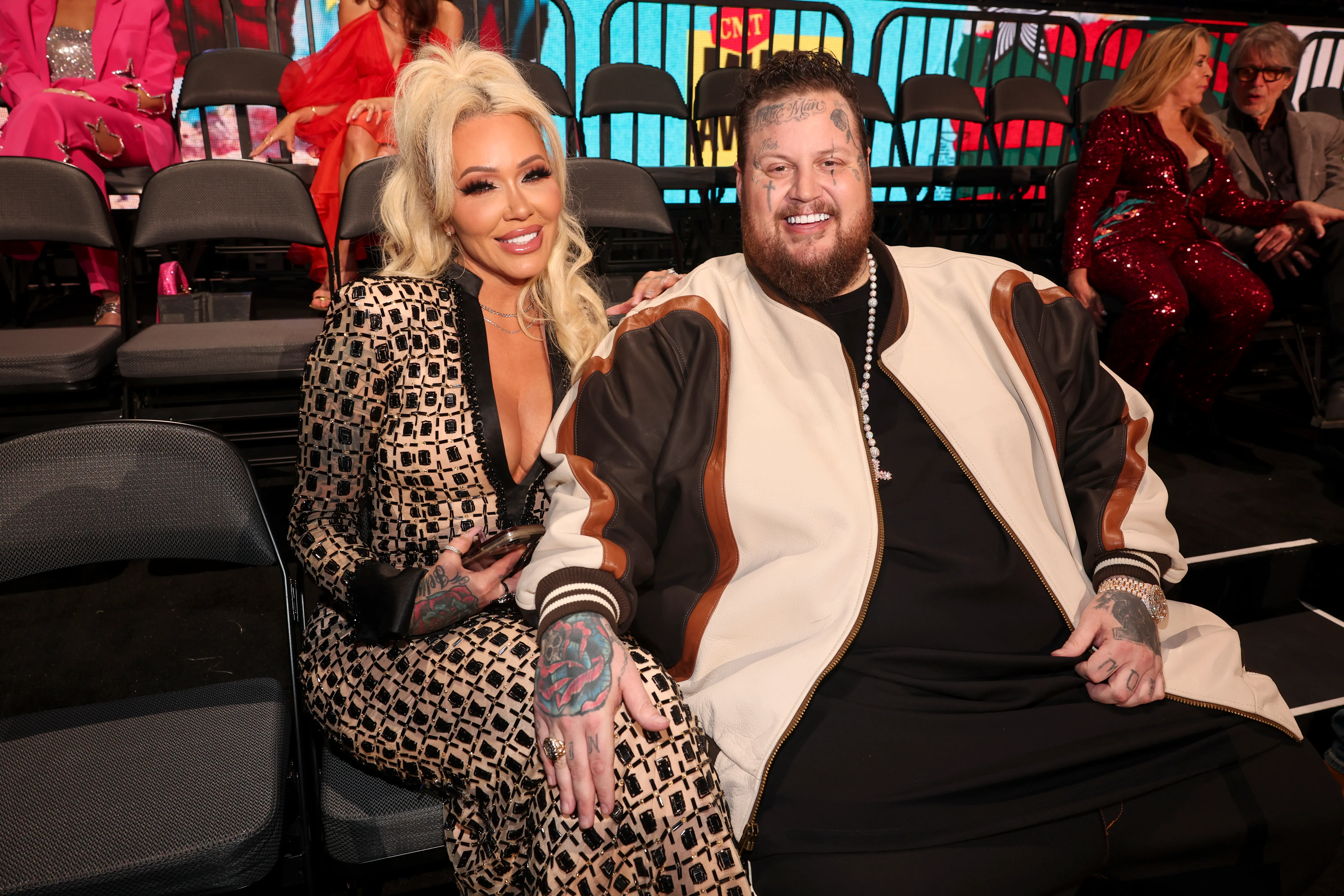 Bunnie XO and Jelly Roll sit side by side at an awards ceremony.