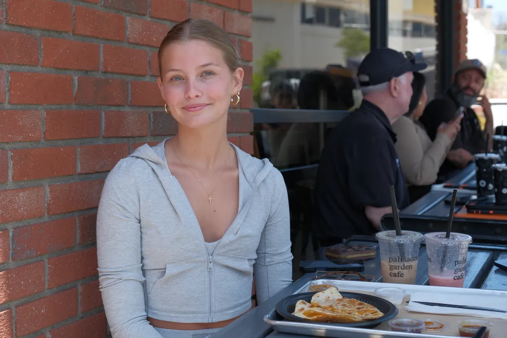 Adalee Foster smiling while sitting at a table with drinks and quesadillas.