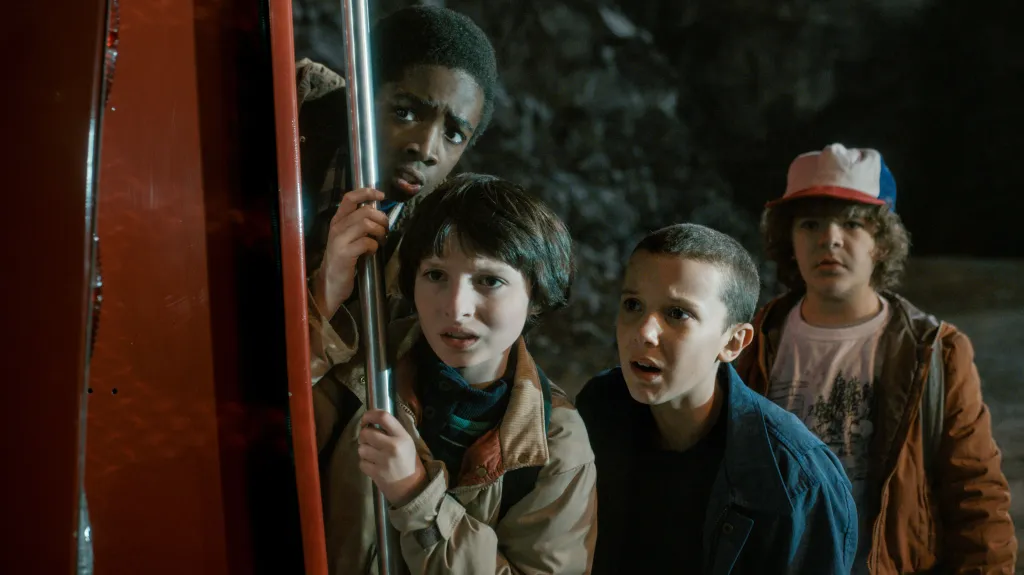Four young friends looking intensely at something to the left of the frame.