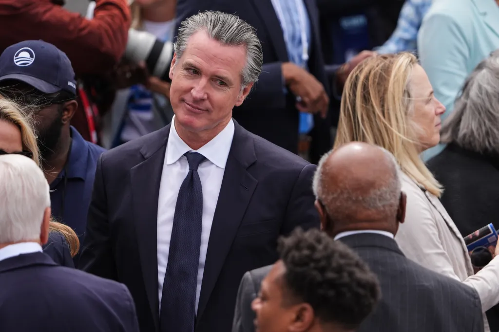 Gavin Newsom, California Governor, standing among a crowd of people.
