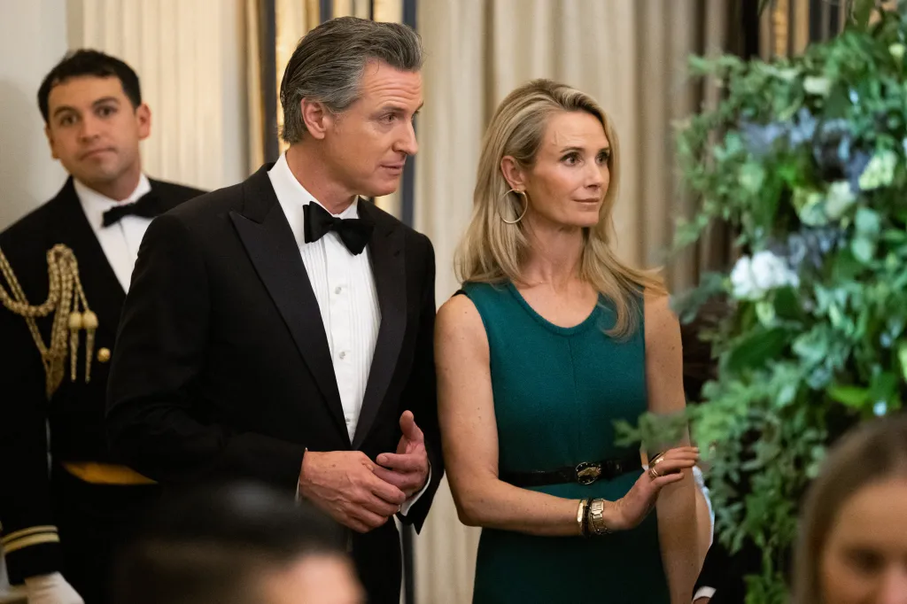 Gavin Newsom and Jennifer Siebel Newsom attending a black-tie dinner.