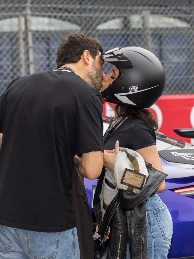 Camila Cabello, wearing a black racing helmet, kisses Henry Junior Chalhoub at the Monaco E-Prix.