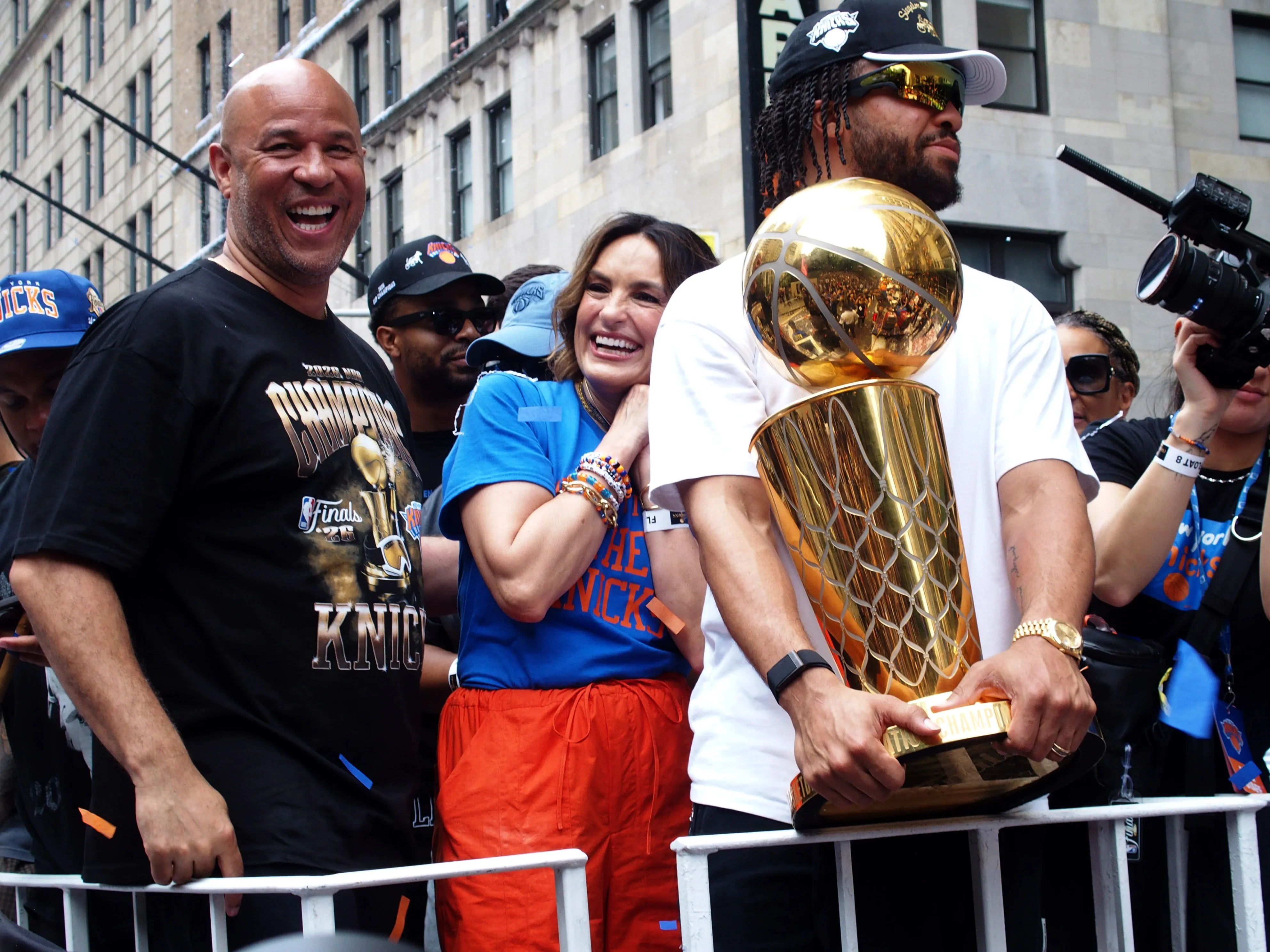 Rick Brunson, Mariska Hargitay, and Jalen Brunson celebrate during a New York Knicks ticker-tape parade.