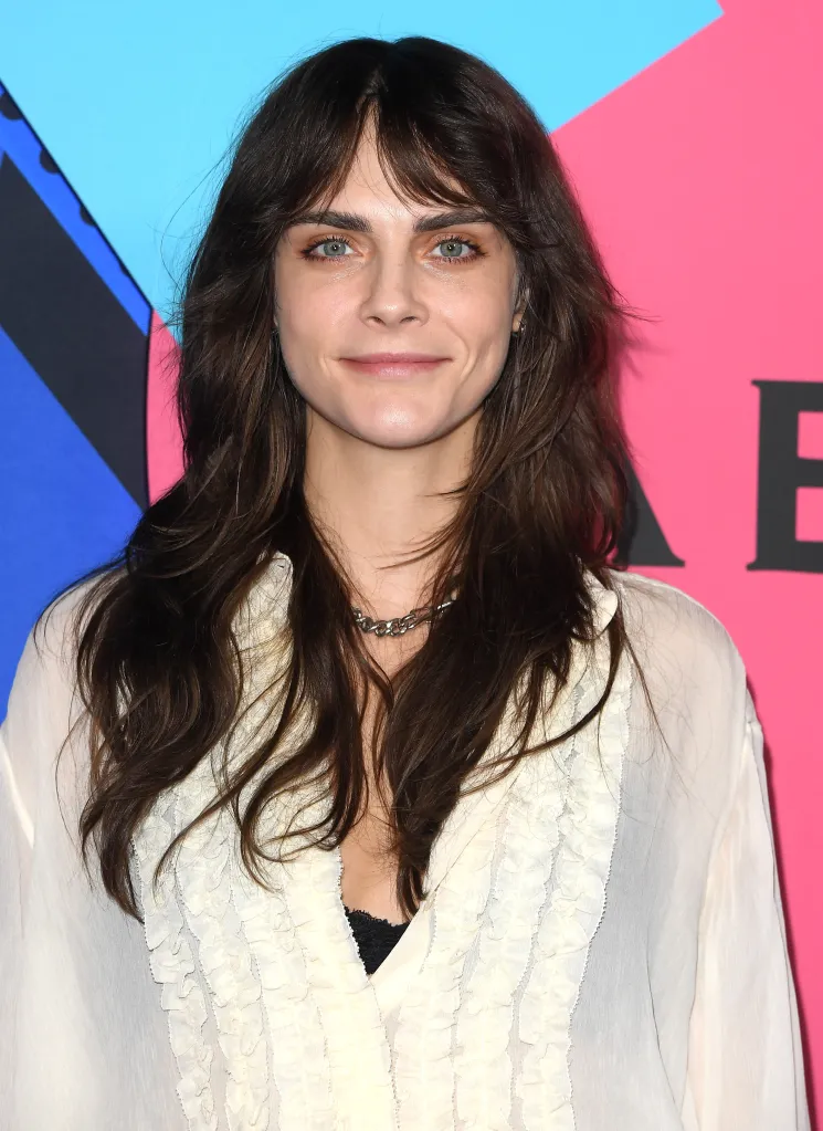 Cara Delevingne smiling at the Abbey's 35th Anniversary.