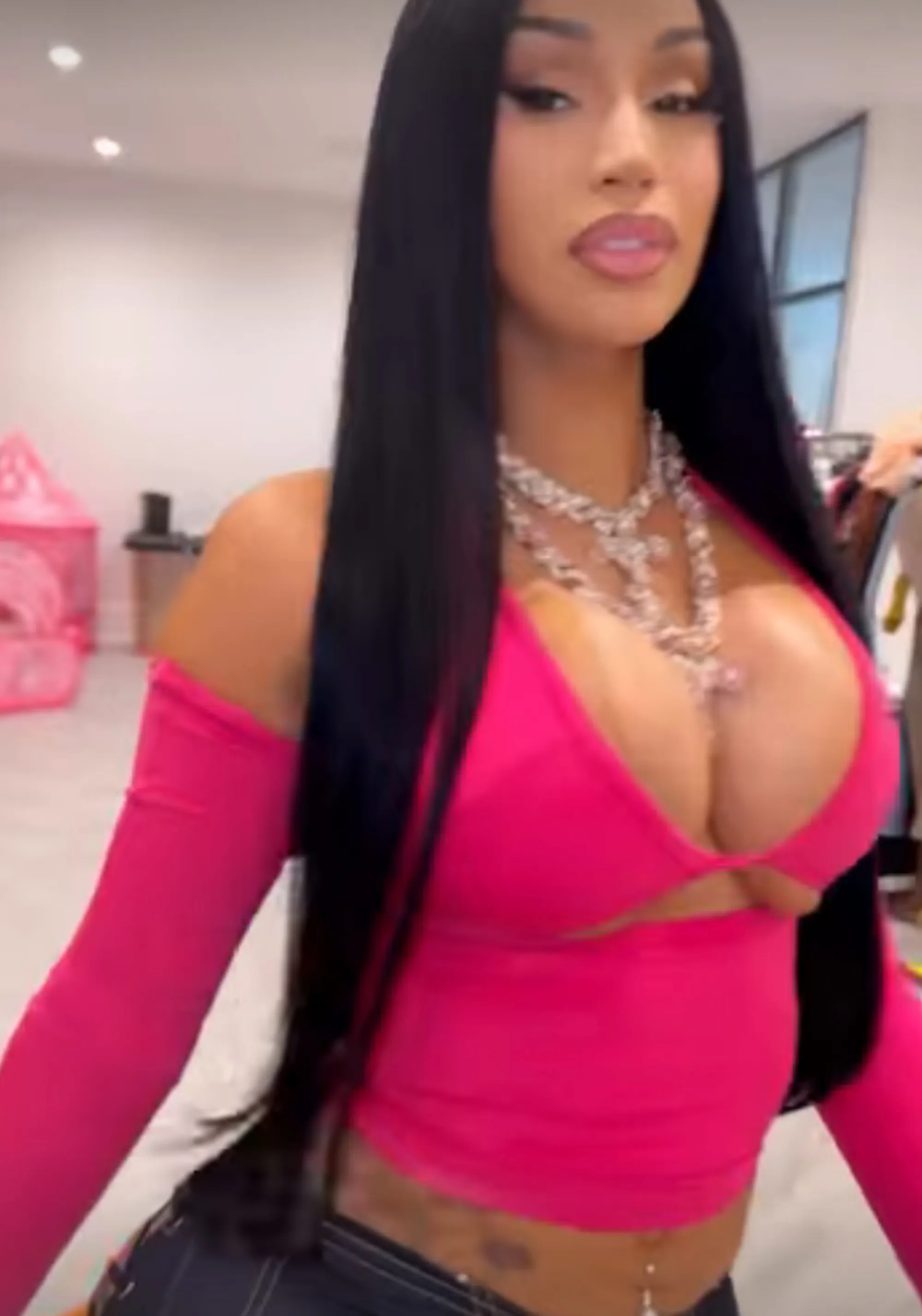 Cardi B in a racy pink top, celebrating a Knicks win.