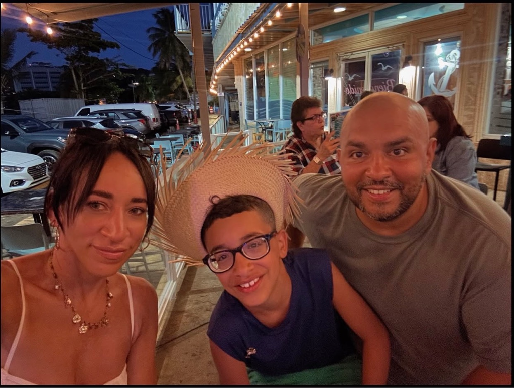 Angelisa, Carmelo, and Felix at an outdoor restaurant.