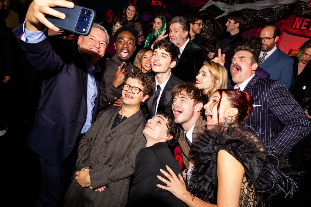 Ted Sarandos and the cast of Stranger Things pose for a group selfie.