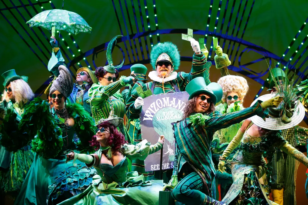 A scene from the musical, showing cast members in green costumes.