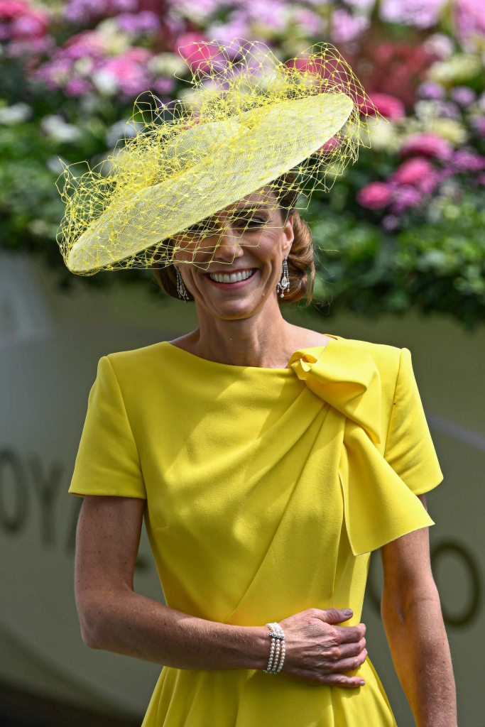 Catherine, Princess of Wales, smiling in a yellow dress and a yellow fascinator at Royal Ascot.