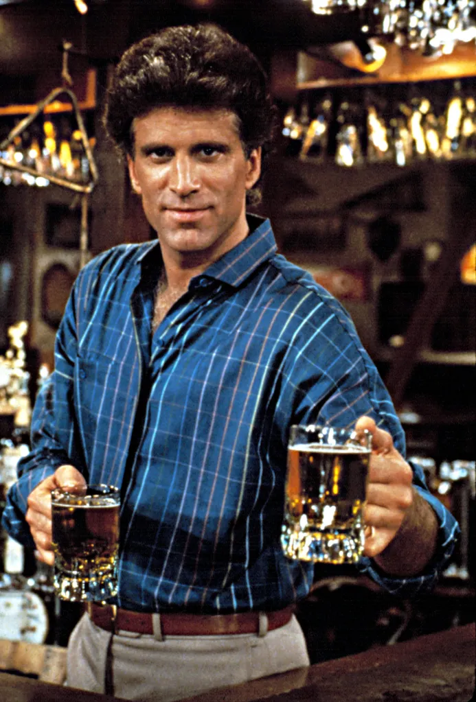 Ted Danson as Sam Malone from Cheers, holding up two mugs of beer.
