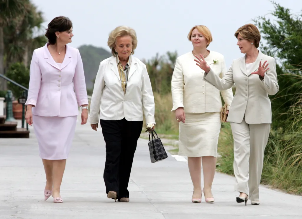 From left: Cherie Blair, Bernadette Chirac, Lyudmila Putina, and Laura Bush converse as they walk to a press conference site.