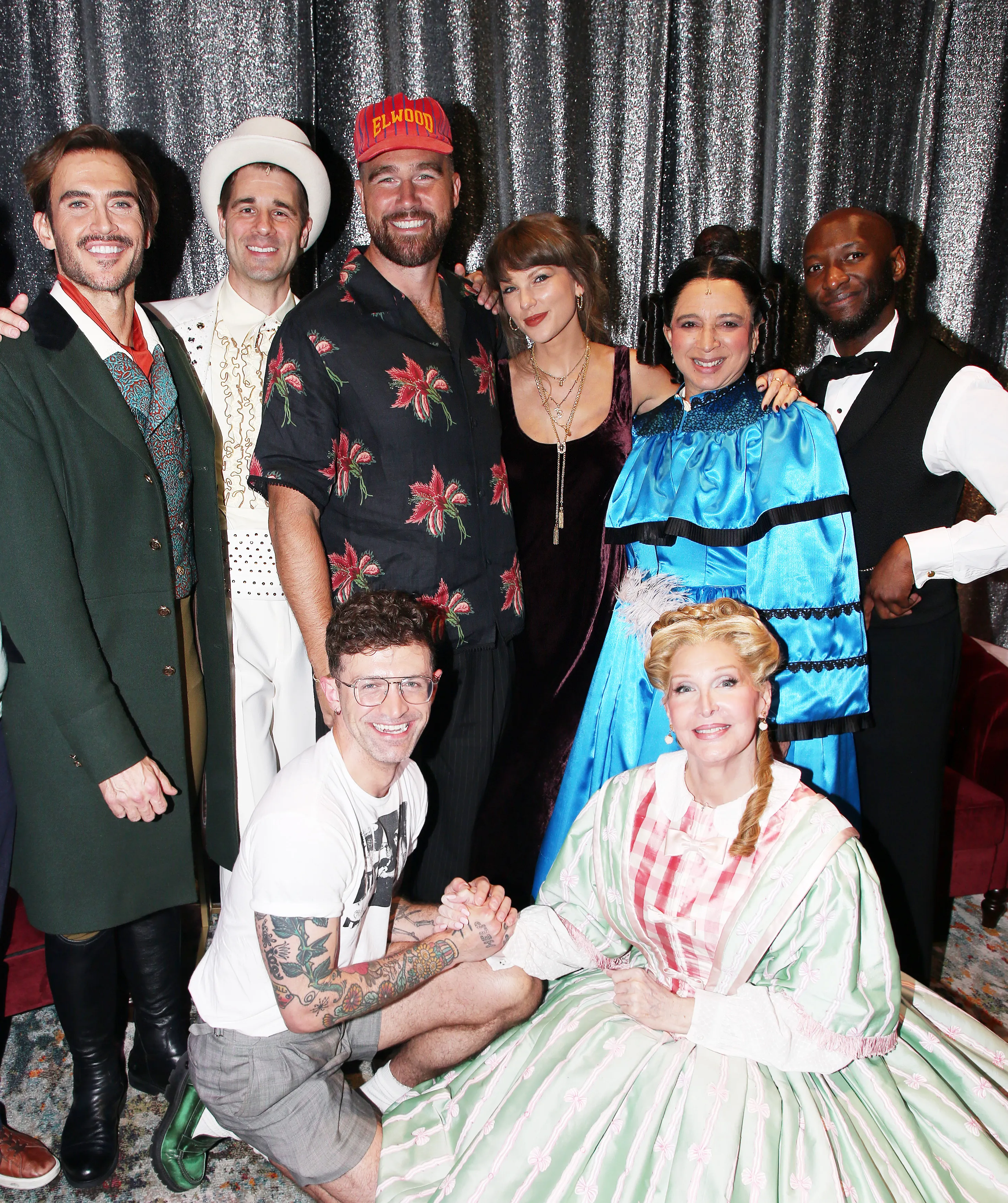 Taylor Swift and Travis Kelce pose backstage with the cast of 