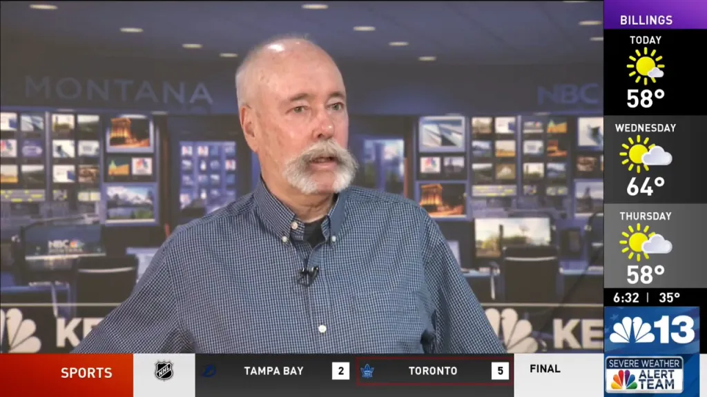 Chris Servheen speaking during an interview in a news studio.