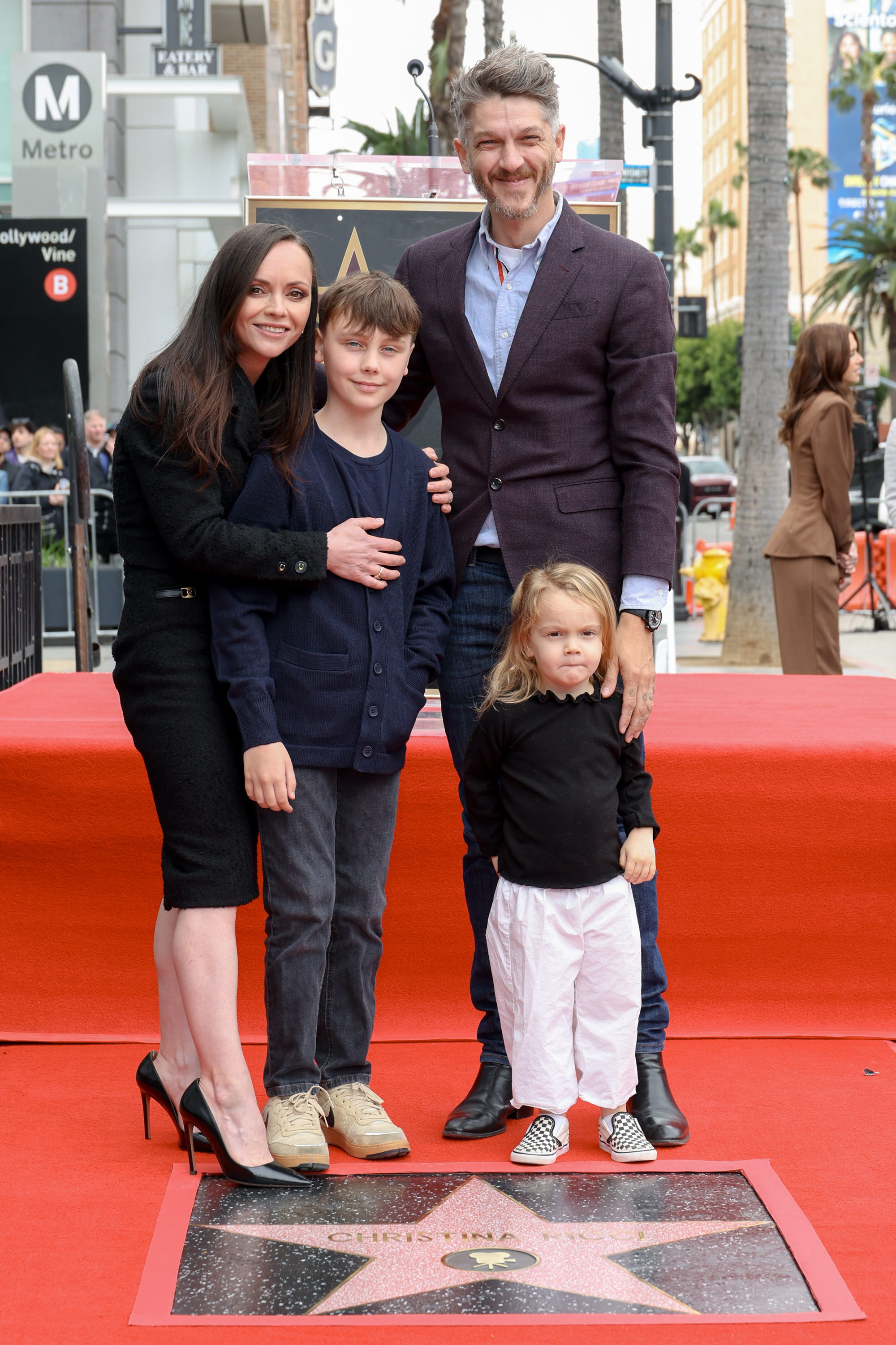 Christina Ricci, her husband Mark Hampton, and their two children pose on the Hollywood Walk of Fame.