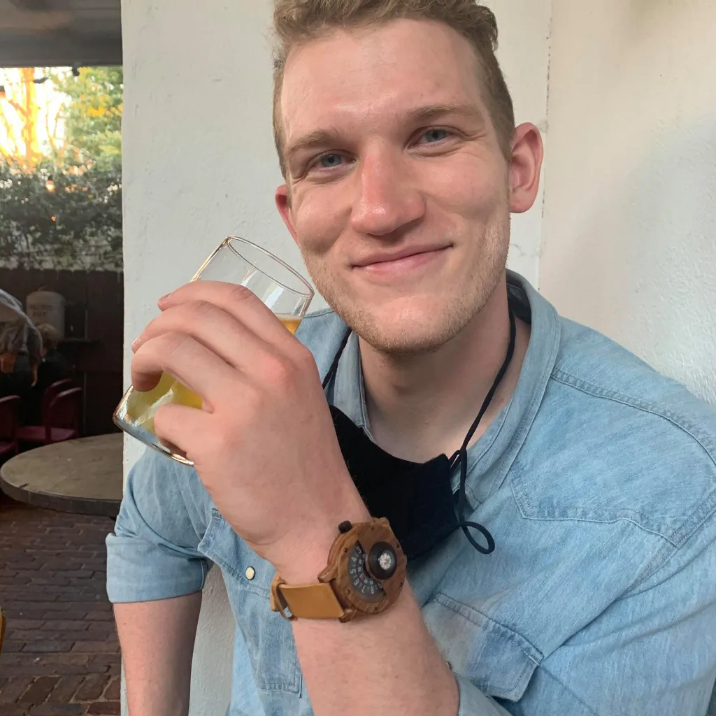 Thomas Clemens, of Oak Park, Illinois, smiles while holding a drink.