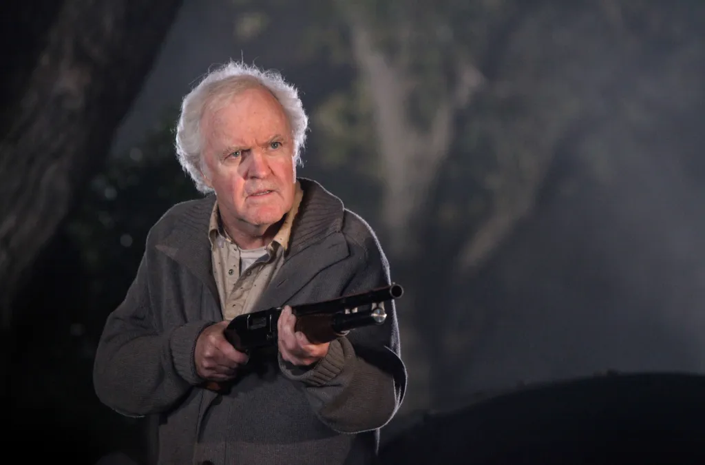 James Handy holding a shotgun on 