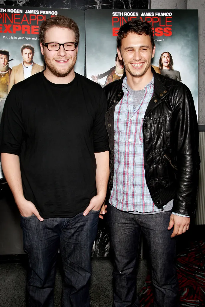 Seth Rogen and James Franco posing in front of a 