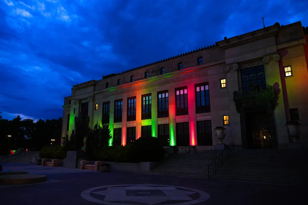 Columbus City Hall lit up in red and green for Juneteenth.