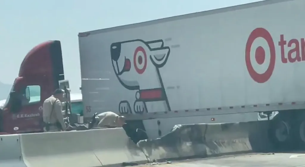 A semi-truck with a Target trailer crashed onto the median of the 210 Freeway, causing significant damage and traffic impacts.