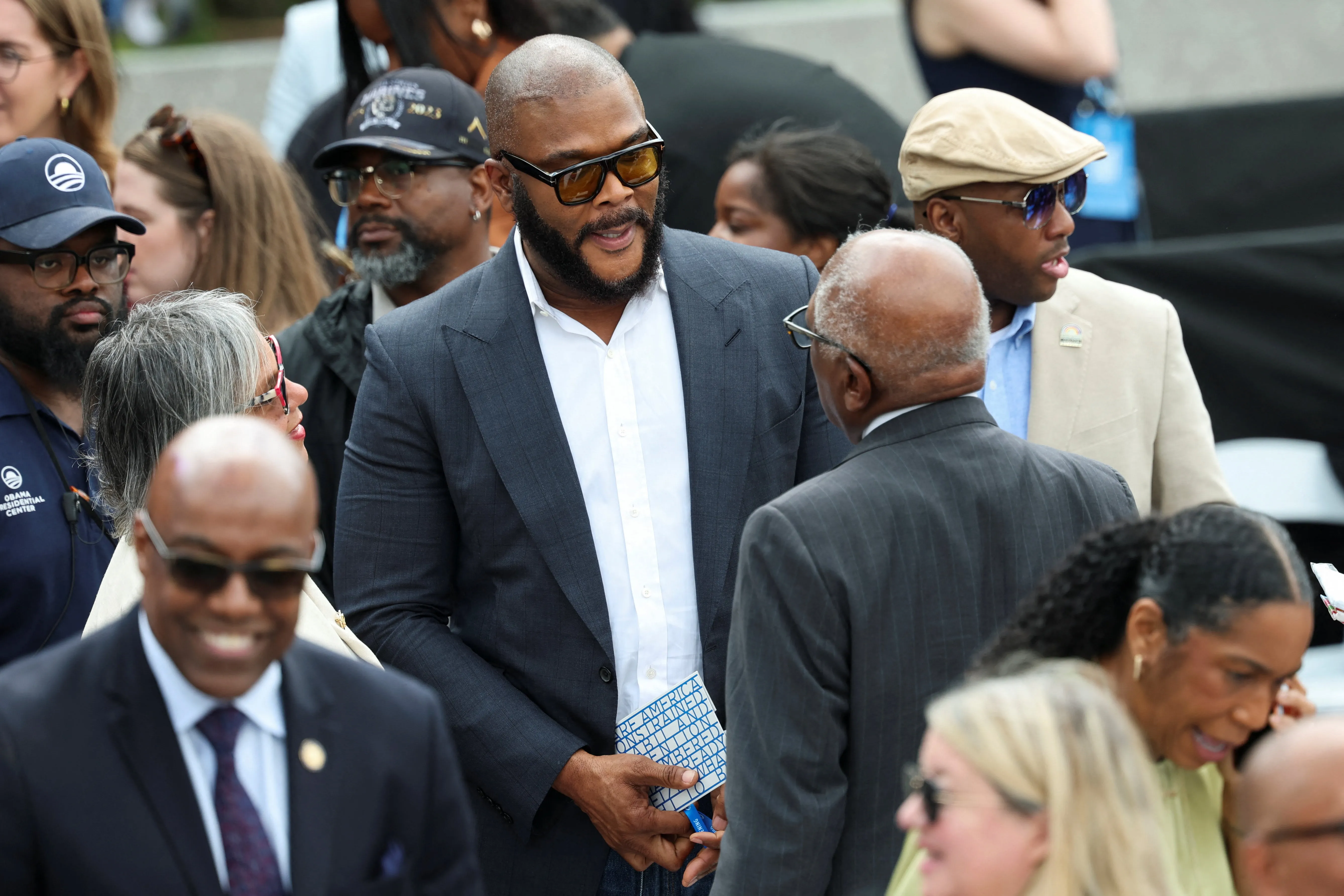 Tyler Perry speaks with U.S. Representative James Clyburn at a dedication ceremony for the opening of the Obama Presidential Center in Chicago.