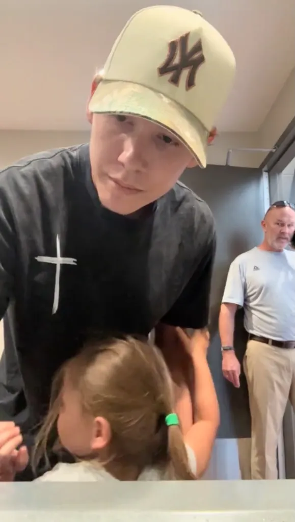 Tyler Brodsky with his daughter, and another man in the background.