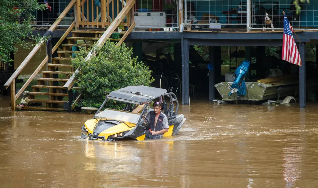 Dalton Saacks moving a mud buggy from the rising Tchefuncte River ahead of Tropical Storm Arthur.