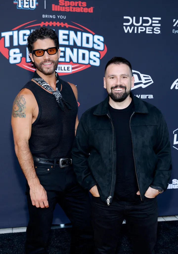 Dan Smyers and Shay Mooney of Dan + Shay pose together on a red carpet.