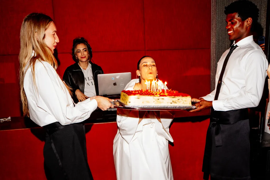 Daniella Kallmeyer blowing out birthday candles on a cake.