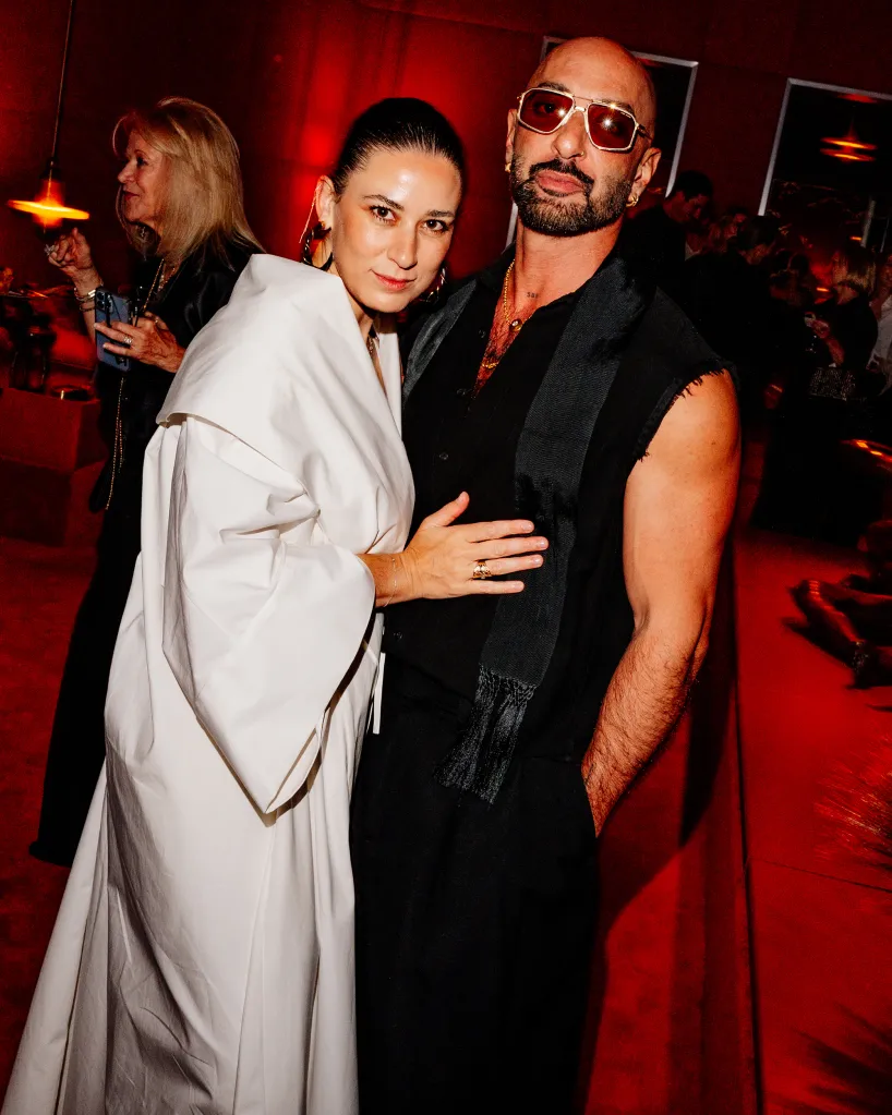 Daniella Kallmeyer in white and Gabriel Hendifar in black pose together.