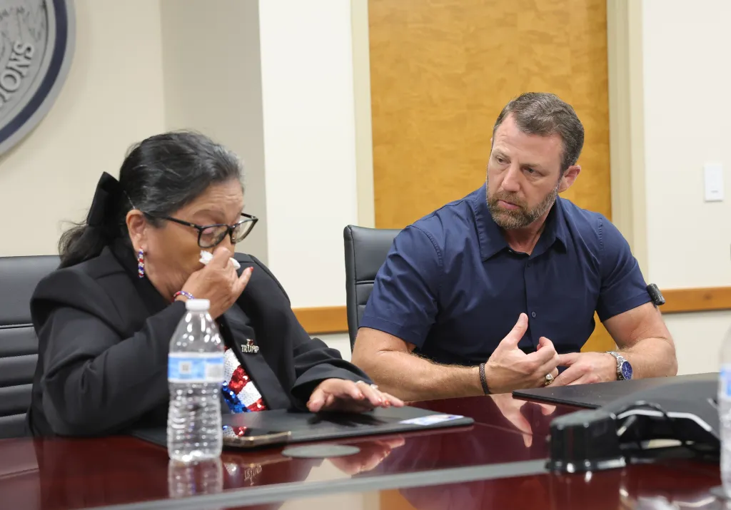 DHS Secretary Markwayne Mullin converses with Angie Morfin, who is seen wiping tears from her eye, at the Los Angeles ICE Field Office.