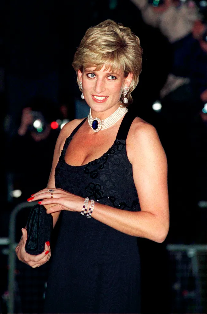 Princess Diana at a gala evening in a black Jacques Azagury gown, pearl choker with a large sapphire pendant, and matching sapphire and pearl earrings and bracelet.