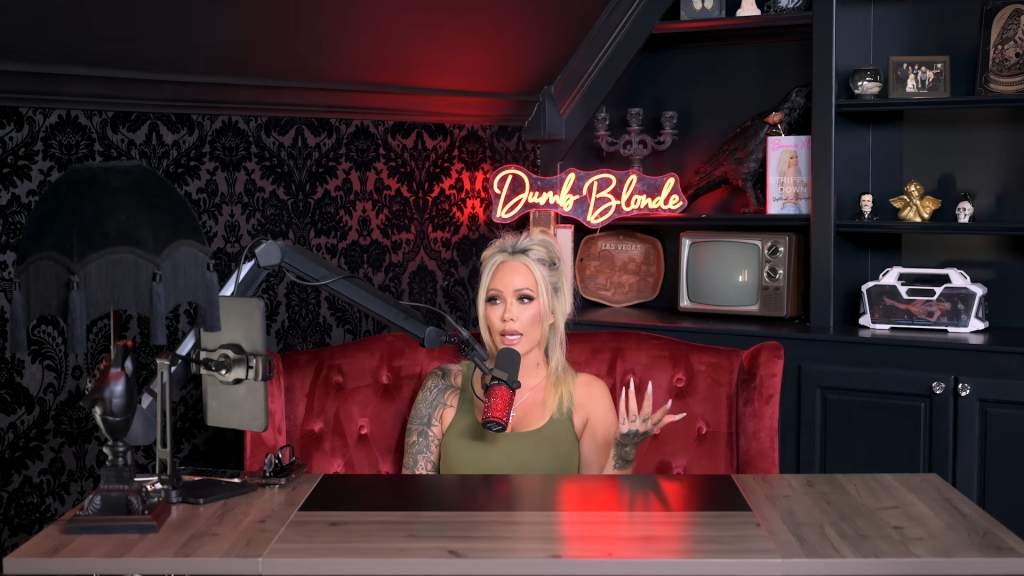 Bunnie XO speaking into a microphone in a dark room with a 