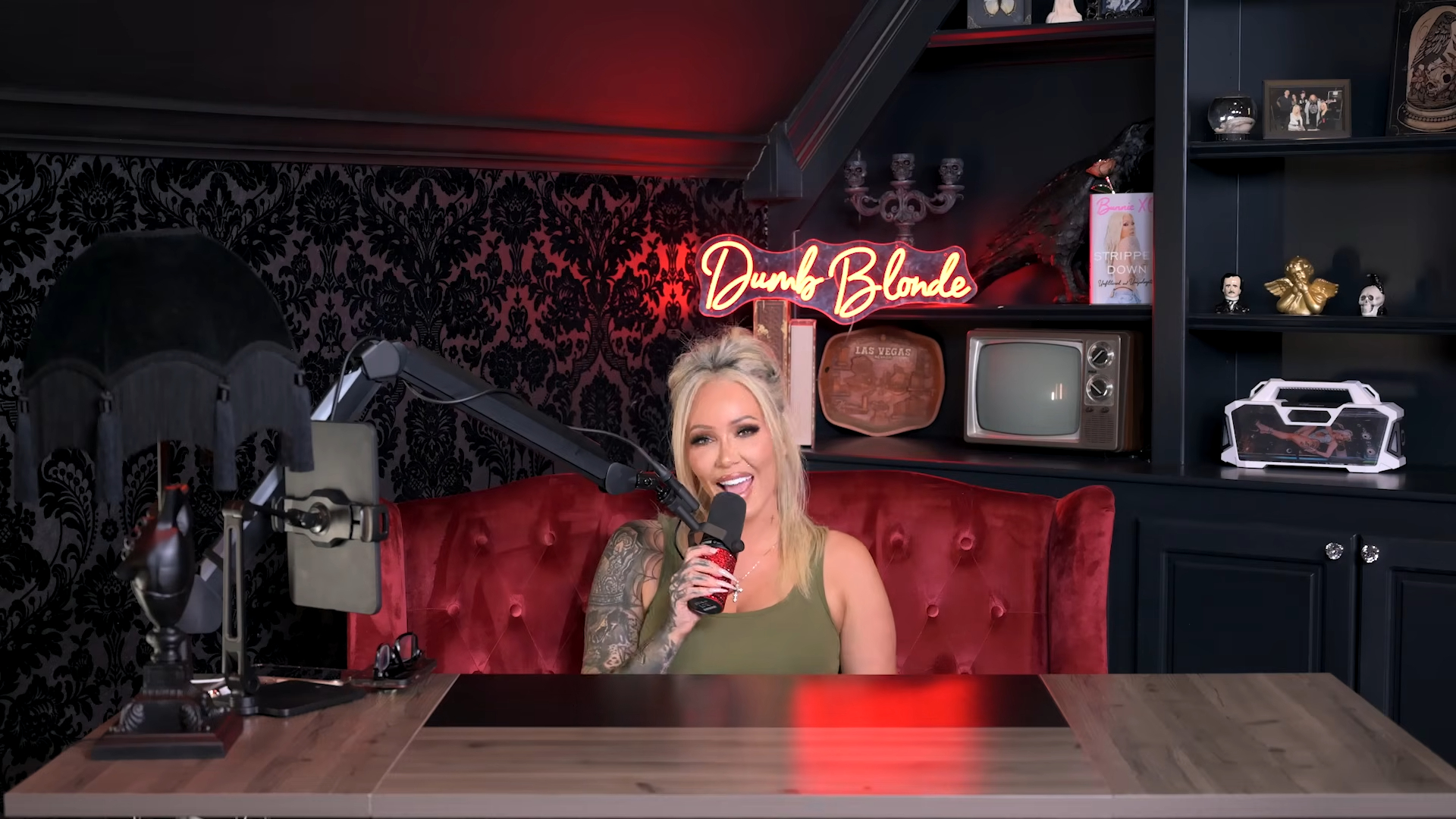Bunnie XO speaking into a microphone on her YouTube channel, Dumb Blonde.