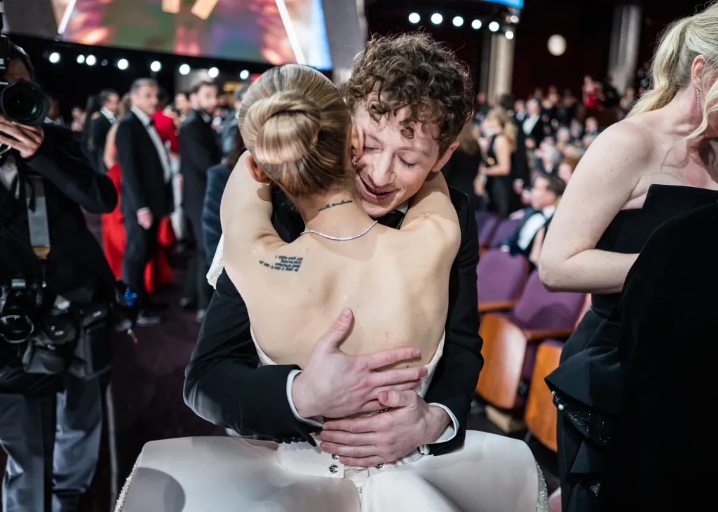 Ariana Grande hugging Ethan Slater at the 97th Annual Oscars.