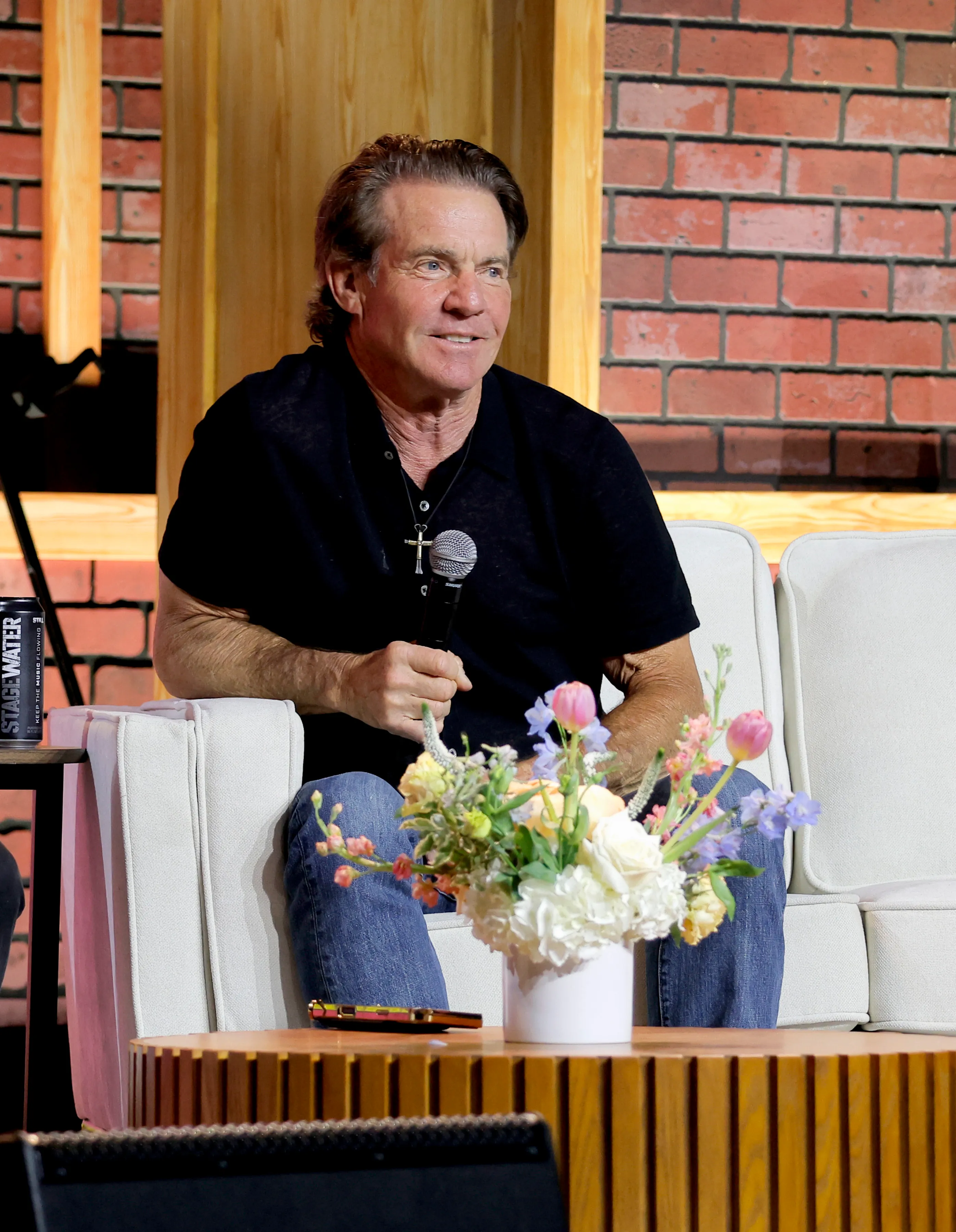 Dennis Quaid speaking on stage at CMA Fest 2026.