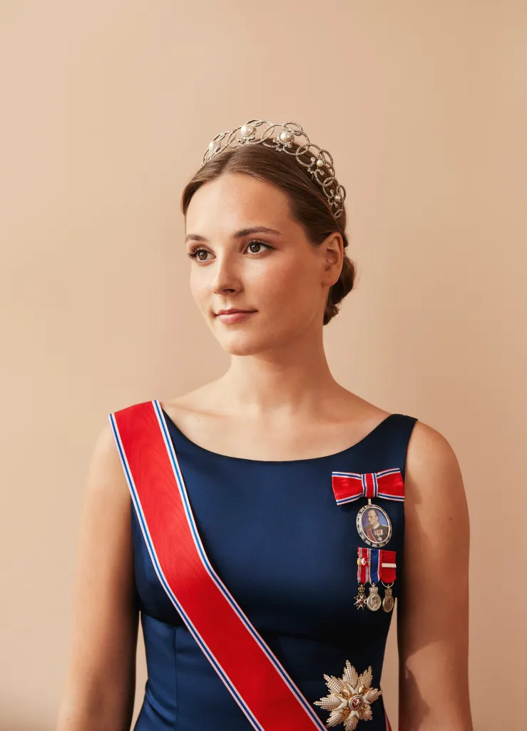 Portrait of Princess Ingrid Alexandra of Norway wearing a tiara, blue gown, and royal orders.