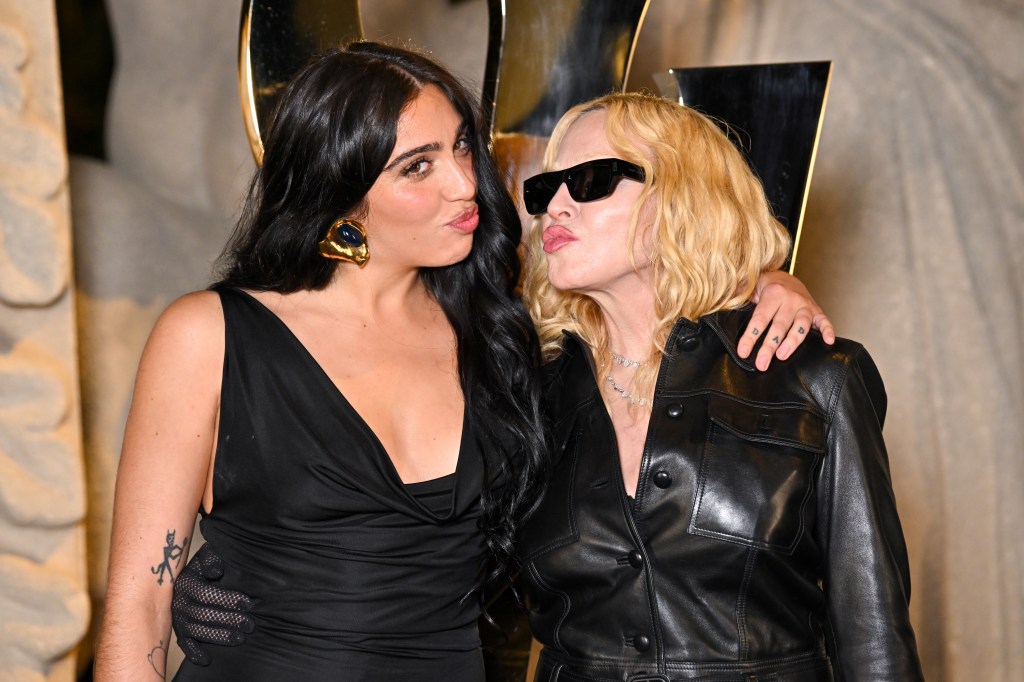 Lourdes Leon and Madonna posing together, making kissy faces at the Saint Laurent Womenswear Spring/Summer 2026 show.