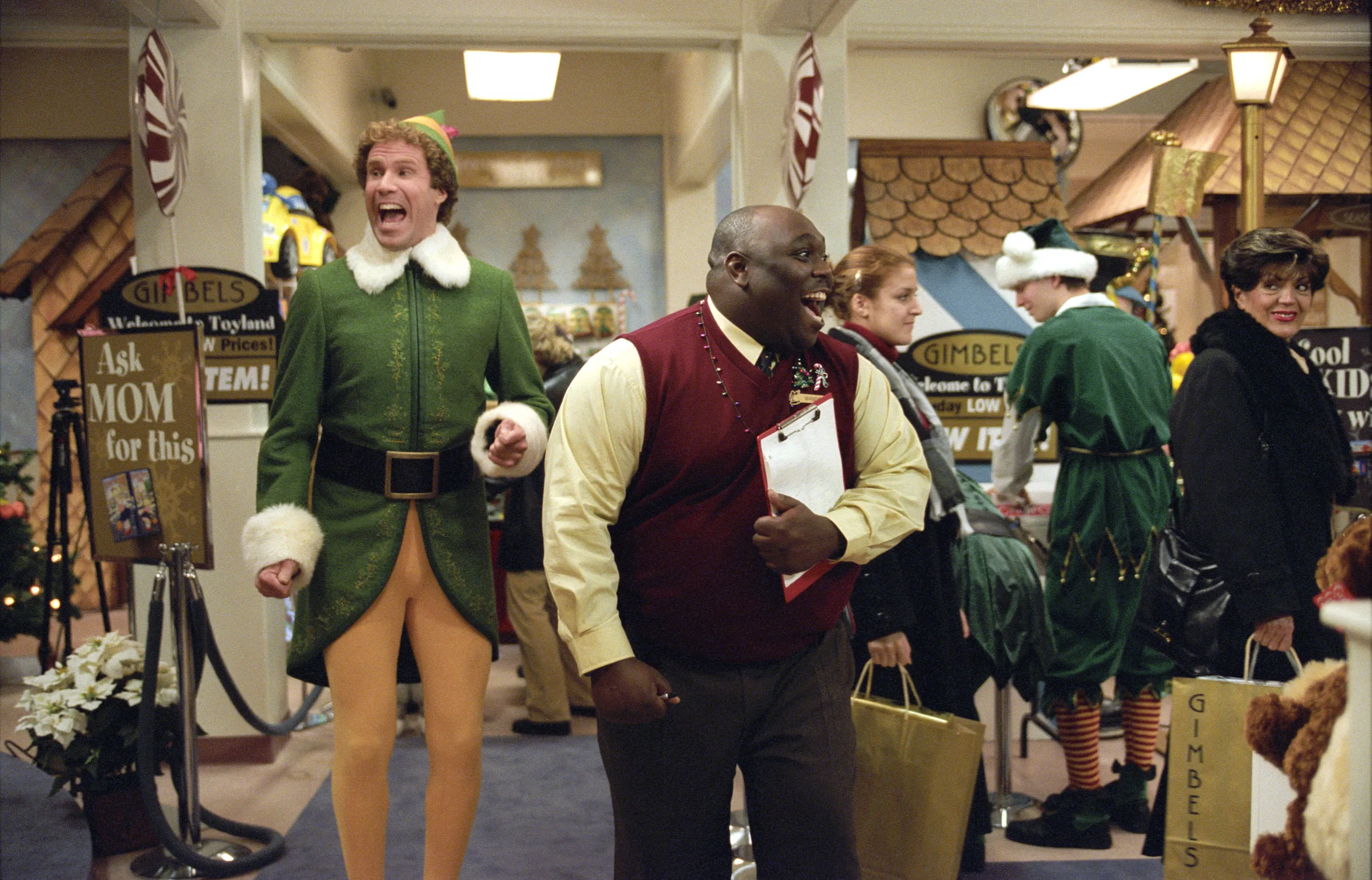 Will Ferrell as Buddy the Elf and Faizon Love as a Gimbels manager, both open-mouthed, in the 2003 film 