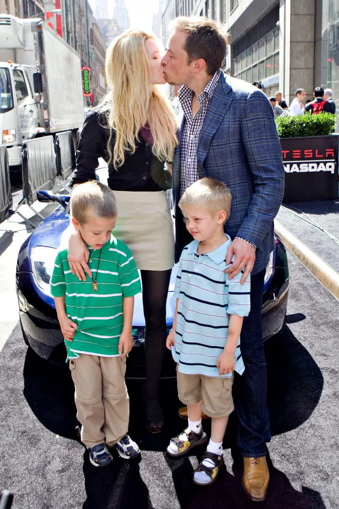 Elon Musk and Talulah Riley kiss with Musk's twin boys, Griffin and Xavier, at the Nasdaq Marketsite in New York for Tesla Motors' IPO.