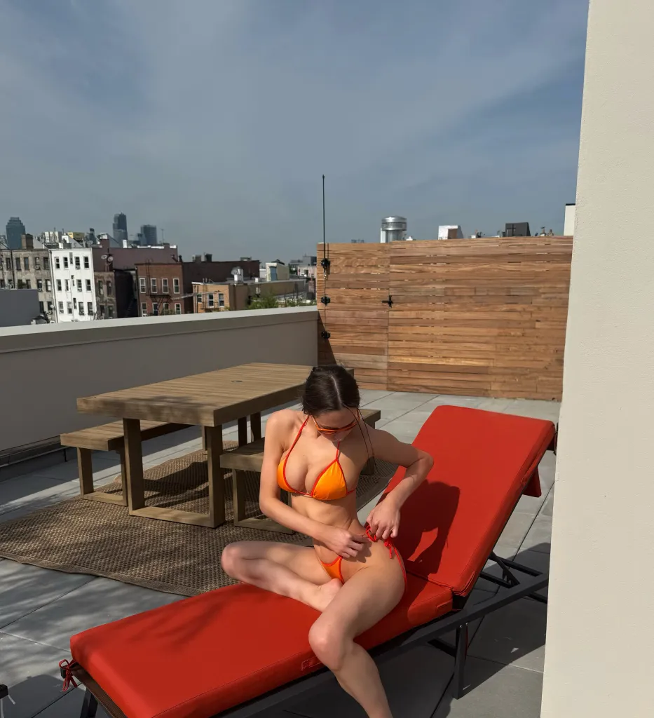 Elsie Hewitt in a bikini on a rooftop.