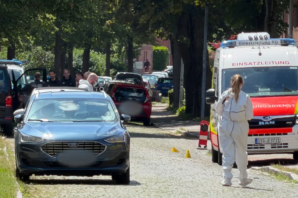 Emergency responders and forensic investigators on a street in Stade following a shooting.