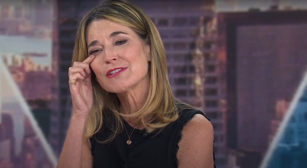 Savannah Guthrie wiping a tear from her eye.