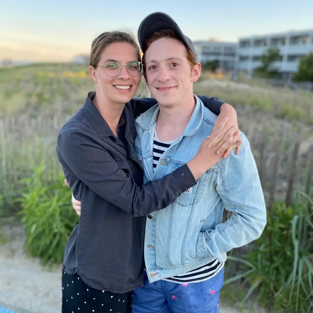 Ethan Slater, in a denim jacket, black and white striped T-shirt and baseball cap, with his wife Lilly Jay, in a grey jacket and polka dot skirt.