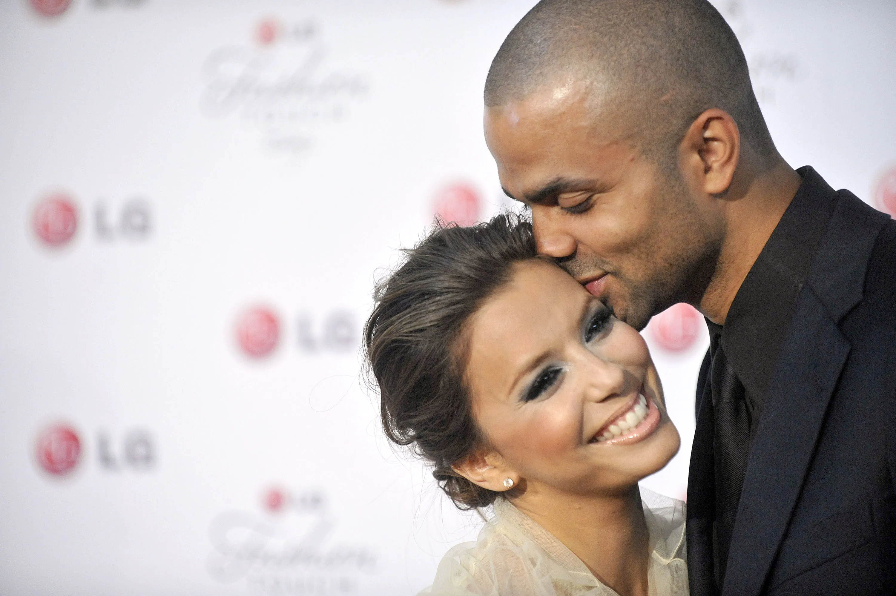 Eva Longoria Parker and Tony Parker pose for a picture at the Victoria Beckham and Eva Longoria Parker Night of Fashion & Technology with LG Phones event.